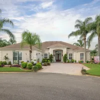 stucco Florida home with palm trees