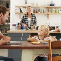 Father and son coloring in kitchen