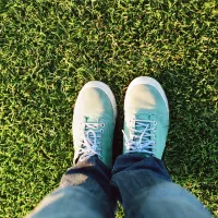 Someone standing on green healthy grass