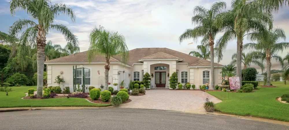 stucco Florida home with palm trees