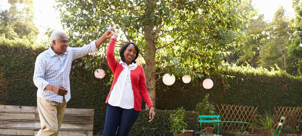 older couple dancing outside in yard
